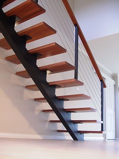 Steel mono-stringer stair with wood treads and cable rail