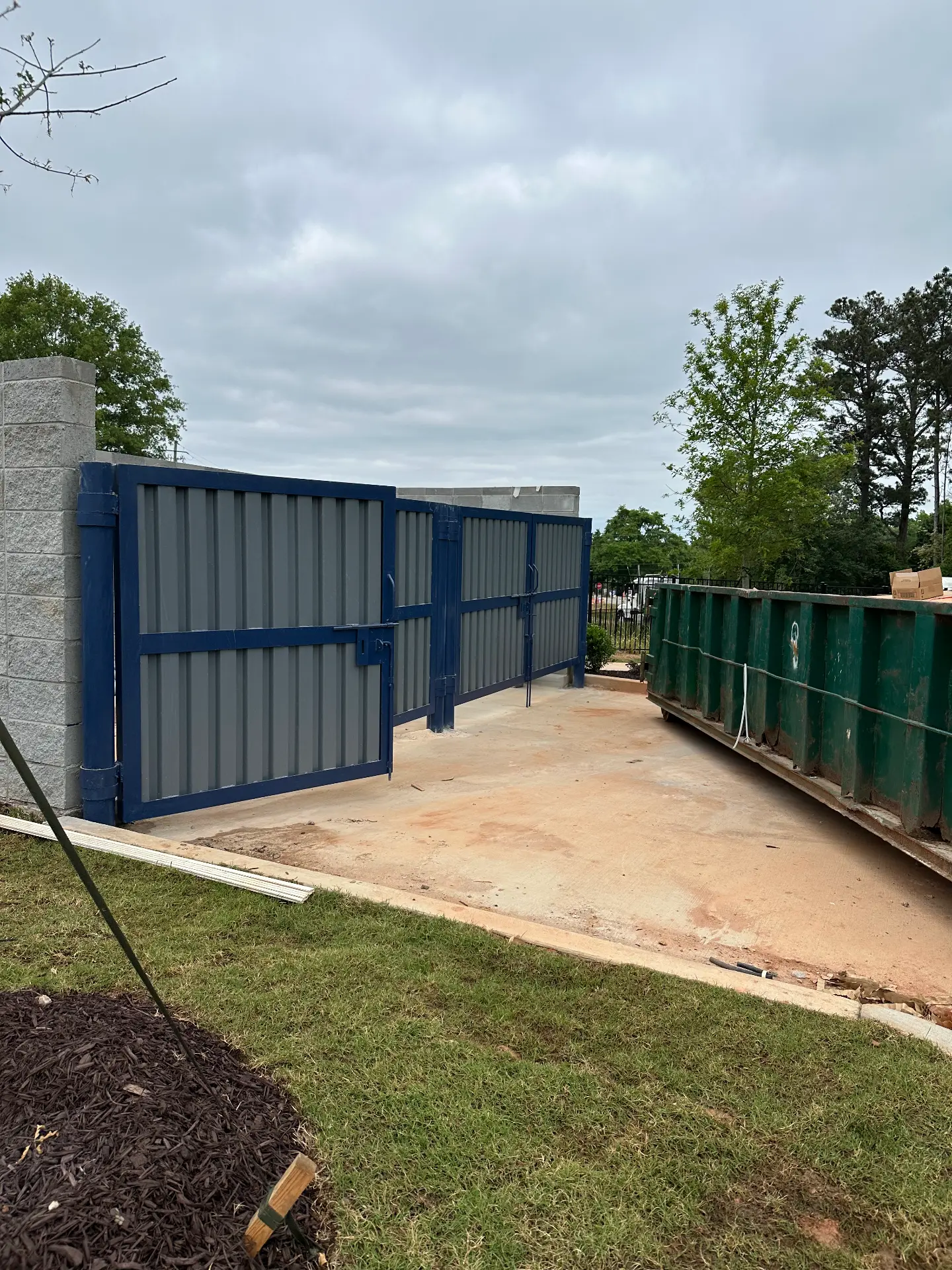 Blue steel dumpster enclosure gates