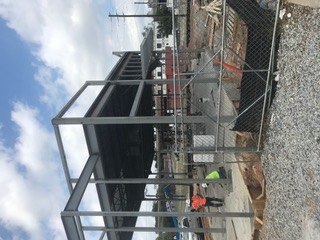 Grey structural steel frame for a two-story commercial build
