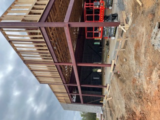 Red steel frame with wood-framed second floor
