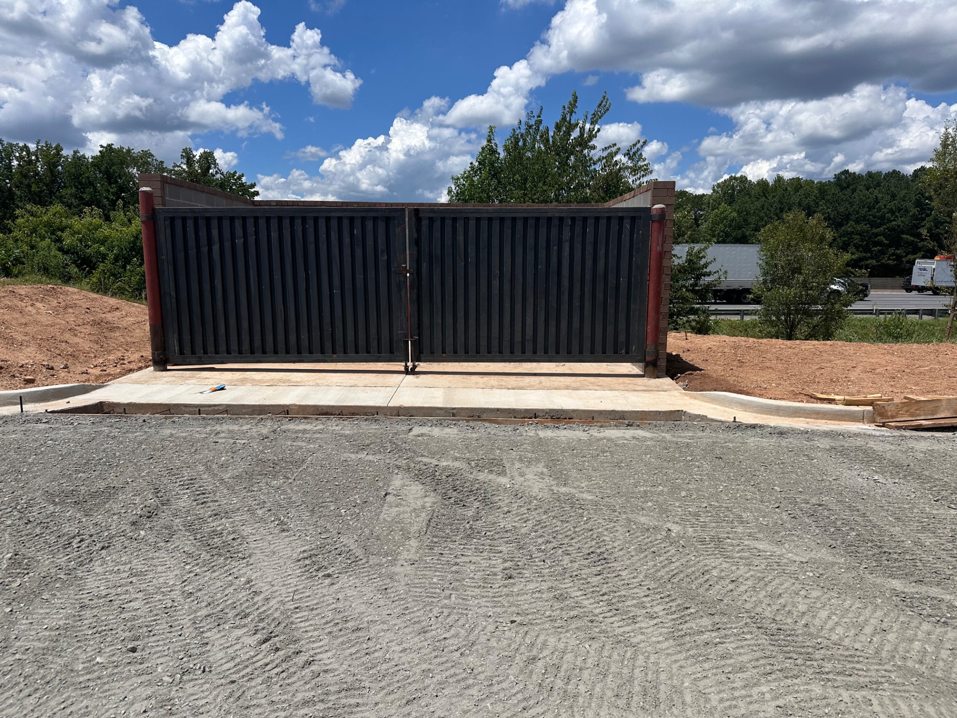 Black steel dumpster enclosure gates